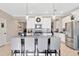 Bright kitchen boasts stainless steel appliances, white cabinetry, and a large island with pendant lighting at 21832 Crest Meadow Dr, Land O Lakes, FL 34637