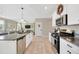 Kitchen with white cabinets, granite countertops and stainless appliances opens to the living room at 21832 Crest Meadow Dr, Land O Lakes, FL 34637