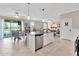 Open kitchen featuring island with sink, adjacent to dining and living areas with a seamless flow at 21832 Crest Meadow Dr, Land O Lakes, FL 34637