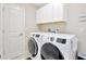Convenient laundry room with modern washer and dryer units, and ample storage at 21832 Crest Meadow Dr, Land O Lakes, FL 34637
