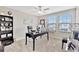 Home office with large desk, shelving, and two bright windows overlooking the neighborhood at 21832 Crest Meadow Dr, Land O Lakes, FL 34637