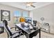 Functional home office with a large desk, comfortable chair, and natural light at 21832 Crest Meadow Dr, Land O Lakes, FL 34637