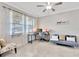 Well-lit home office with a ceiling fan, large windows, and tile flooring at 21832 Crest Meadow Dr, Land O Lakes, FL 34637