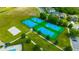 Aerial view of the community tennis and basketball courts surrounded by landscaping and parking at 21832 Crest Meadow Dr, Land O Lakes, FL 34637