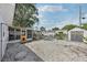 Backyard with screened porch, outdoor shed, and low-maintenance gravel landscaping at 2362 Mary Ln, Clearwater, FL 33763