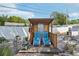 Backyard with lounge chairs under a shaded pergola, fire pit, and low-maintenance landscaping at 2362 Mary Ln, Clearwater, FL 33763