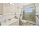 Bright bathroom featuring a glass shower, vanity, and neutral decor at 2362 Mary Ln, Clearwater, FL 33763
