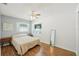 Cozy bedroom featuring wood floors, ample natural light from windows, and a ceiling fan at 2362 Mary Ln, Clearwater, FL 33763