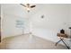 Light-filled bedroom with tile floors, ceiling fan, and a large window for natural light at 2362 Mary Ln, Clearwater, FL 33763