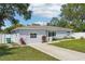 Charming single-story home with well-manicured lawn, concrete driveway, and a white privacy fence at 2362 Mary Ln, Clearwater, FL 33763