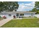 Charming single-story home with well-manicured lawn, white picket fence, and lovely landscaping at 2362 Mary Ln, Clearwater, FL 33763