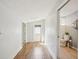Bright hallway with wood floors, leading to a well-lit bathroom and backdoor at 2362 Mary Ln, Clearwater, FL 33763