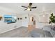 Open-concept living room features a modern sofa, archways, and a mounted flat-screen television at 2362 Mary Ln, Clearwater, FL 33763