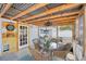Cozy screened patio with wood ceiling, dining table, fan, and view of the backyard at 2362 Mary Ln, Clearwater, FL 33763
