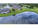 Beautiful overhead shot of a pond, a golf course, and homes in this relaxing community at 2401 Richmond Greens Ct, Sun City Center, FL 33573