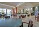 Comfortable dining area with tables, chairs, large windows, and greenery, perfect for relaxing meals at 2401 Richmond Greens Ct, Sun City Center, FL 33573