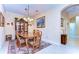 Dining room with wood table, six chairs, china cabinet, decorative rug and lighting at 2401 Richmond Greens Ct, Sun City Center, FL 33573