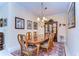 Formal dining room features a wood table, upholstered chairs, and decorative display cabinet at 2401 Richmond Greens Ct, Sun City Center, FL 33573