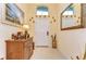 Beautiful foyer with decorative mirror, furniture and an eclectic collection of statuettes at 2401 Richmond Greens Ct, Sun City Center, FL 33573