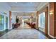 Well-lit hallway with tiled floors and comfortable seating arrangements for residents at 2401 Richmond Greens Ct, Sun City Center, FL 33573