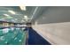 Bright indoor community swimming pool with tile flooring and a tall ceiling at 2401 Richmond Greens Ct, Sun City Center, FL 33573