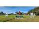 Enjoy the community lawn bowling green with seating under sunny skies at 2401 Richmond Greens Ct, Sun City Center, FL 33573