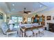Open living room with tray ceilings, tile floors, comfortable seating, and access to the patio at 2401 Richmond Greens Ct, Sun City Center, FL 33573