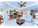 Spacious living area with tray ceilings, neutral decor, comfortable seating, and tile flooring at 2401 Richmond Greens Ct, Sun City Center, FL 33573