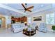 Bright open-concept living room with view of the kitchen, neutral palette, and comfortable furnishings at 2401 Richmond Greens Ct, Sun City Center, FL 33573