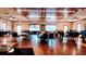 Community center meeting room with round tables, chairs, and polished hardwood floors at 2401 Richmond Greens Ct, Sun City Center, FL 33573