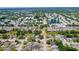 Extensive aerial shot displaying the neighborhood layout, with an arrow indicating the home's location at 2930 S Pines Dr # 109, Largo, FL 33771