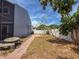 Backyard with tiled pathway, decorative mosaic table, and perimeter fence at 2930 S Pines Dr # 109, Largo, FL 33771