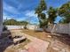 Backyard with tiled pathway, decorative mosaic table, and perimeter fence at 2930 S Pines Dr # 109, Largo, FL 33771