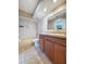 Bathroom featuring tiled floors, bathtub and shower combo, vanity with sink, and updated lighting at 2930 S Pines Dr # 109, Largo, FL 33771