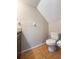 Bathroom featuring tiled floors, toilet, and updated lighting at 2930 S Pines Dr # 109, Largo, FL 33771