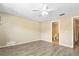 This bedroom features a ceiling fan, durable wood-look flooring and access to an attached bathroom at 2930 S Pines Dr # 109, Largo, FL 33771