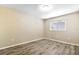 Cozy bedroom with wood-look flooring and a window that provides natural light at 2930 S Pines Dr # 109, Largo, FL 33771
