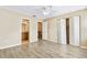 This bedroom features a connecting bathroom, closet, ceiling fan, and durable wood-look flooring at 2930 S Pines Dr # 109, Largo, FL 33771