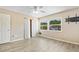 Bright bedroom features a ceiling fan, large window offering ample natural light, closet and durable wood-look flooring at 2930 S Pines Dr # 109, Largo, FL 33771
