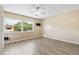 Bright bedroom features a ceiling fan, large window offering ample natural light and durable wood-look flooring at 2930 S Pines Dr # 109, Largo, FL 33771
