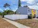 Charming townhome with a white picket fence and blue and yellow exterior at 2930 S Pines Dr # 109, Largo, FL 33771