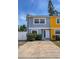 Exterior view of the two-story home, driveway, and front yard foliage at 2930 S Pines Dr # 109, Largo, FL 33771