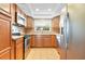 Well-equipped kitchen featuring stainless steel appliances, wood cabinets, and a window over the sink at 2930 S Pines Dr # 109, Largo, FL 33771