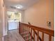 Upstairs hallway featuring a laundry closet with a stacked washer and dryer at 2930 S Pines Dr # 109, Largo, FL 33771