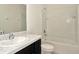 A bathroom featuring a tub/shower combination with white tile and dark wood cabinets at 2949 Suncoast Plains Dr, Odessa, FL 33556