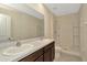 A bathroom with a double sink, white countertops, and a shower over a tub at 2949 Suncoast Plains Dr, Odessa, FL 33556