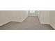 A bedroom with gray carpet features a window with blinds and white walls at 2949 Suncoast Plains Dr, Odessa, FL 33556