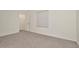 A bright bedroom with light gray carpet and white walls at 2949 Suncoast Plains Dr, Odessa, FL 33556