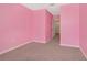Bright pink bedroom with carpeted floors and white trim at 2949 Suncoast Plains Dr, Odessa, FL 33556
