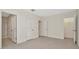 A bedroom with light gray carpet features a door to a shower and a closet at 2949 Suncoast Plains Dr, Odessa, FL 33556